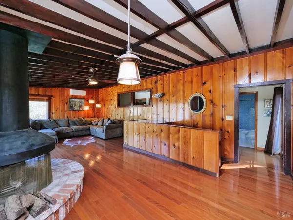a room with gym equipment and wooden floor