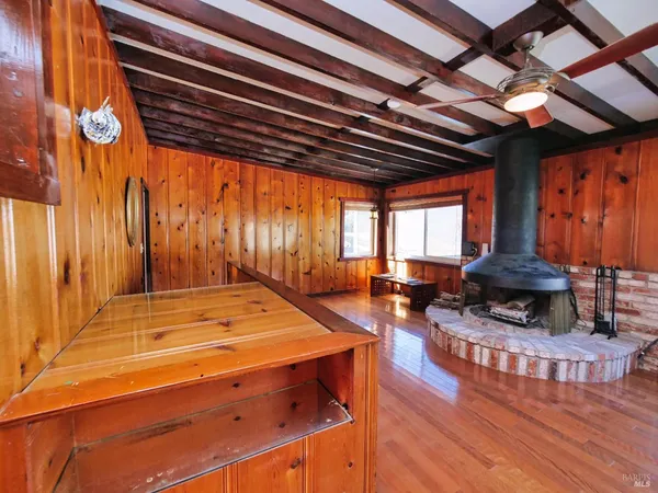 a view of backyard with tub and barbeque oven