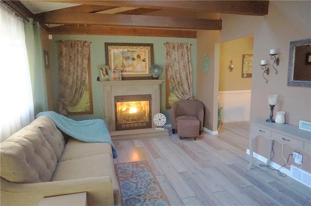 110 Sturm Lane Rochester, PA 15074 - Photo 2 of 24 Main floor living room with a propane fireplace and beautiful beams in the ceiling that adds tons of character.
