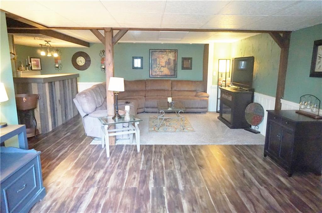 110 Sturm Lane Rochester, PA 15074 - Photo 14 of 24 Lower level family room with bar. Large area for entertaining which also leads out to the sunroom and deck.