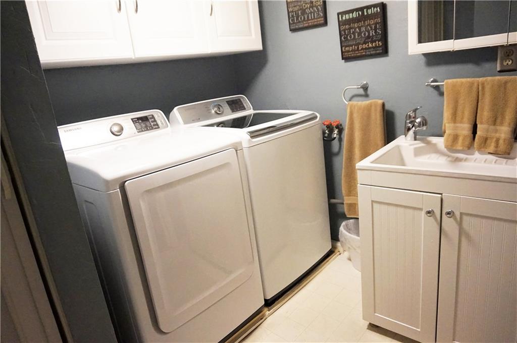 110 Sturm Lane Rochester, PA 15074 - Photo 18 of 24 Laundry room with overhead cabinets and sink.