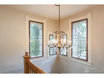 a bedroom with a bed lamps and a large mirror