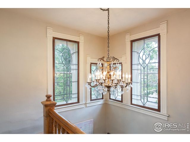 a bedroom with a bed lamps and a large mirror