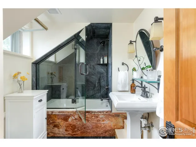 a bedroom with furniture and a flat screen tv