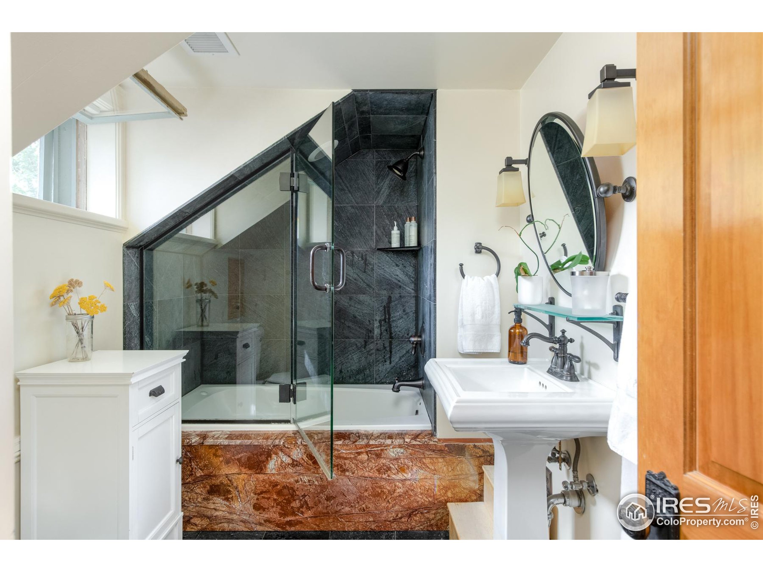 643 Mapleton Avenue Boulder, CO 80304 - Photo 32 of 50 a bathroom with a sink a mirror and shower