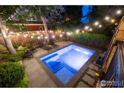 a view of a patio with table and chairs a barbeque with wooden fence