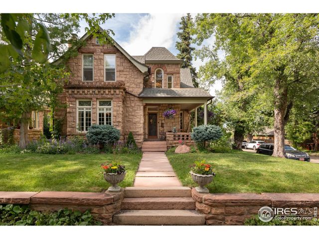 a front view of a house with garden and porch