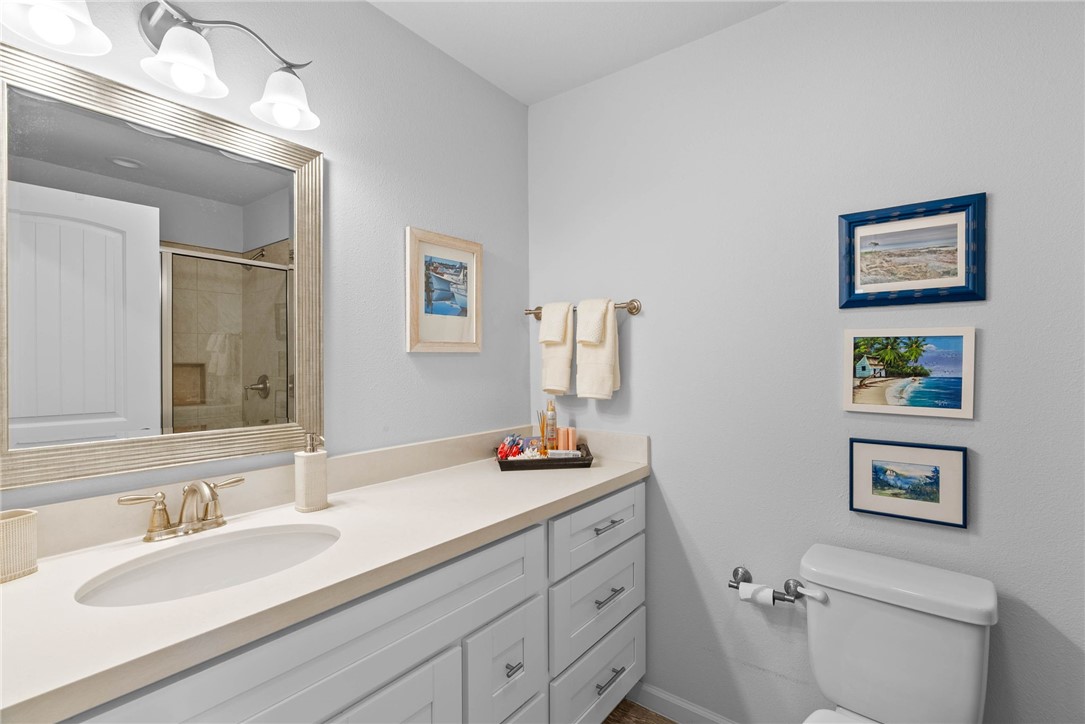 620 South Fulton Beach Road, Unit 611 Rockport, TX 78382 - Photo 14 of 15 a bathroom with a toilet sink and mirror