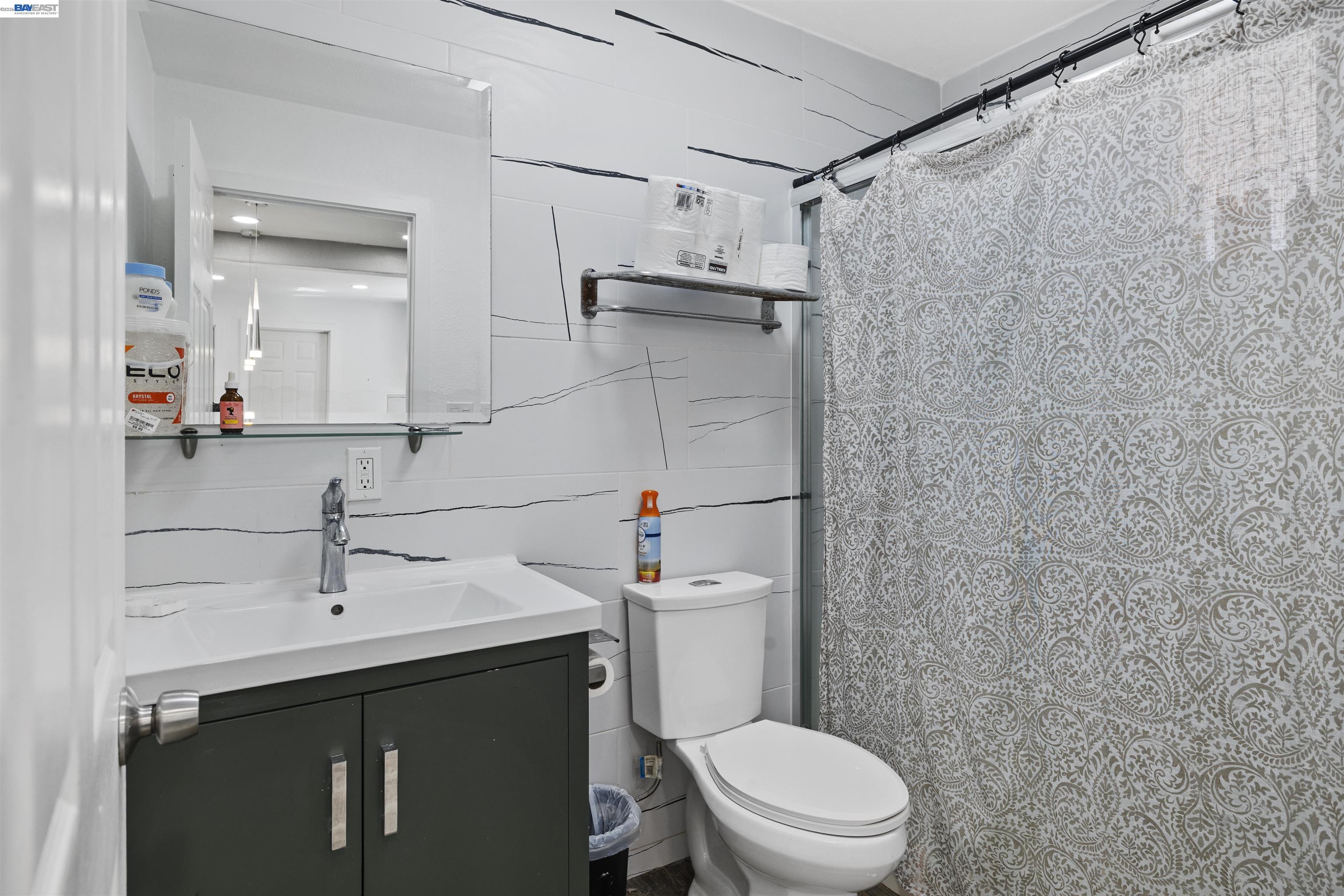923 Kelvin Road El Sobrante, CA 94803 - Photo 17 of 27 a bathroom with a sink a toilet and shower