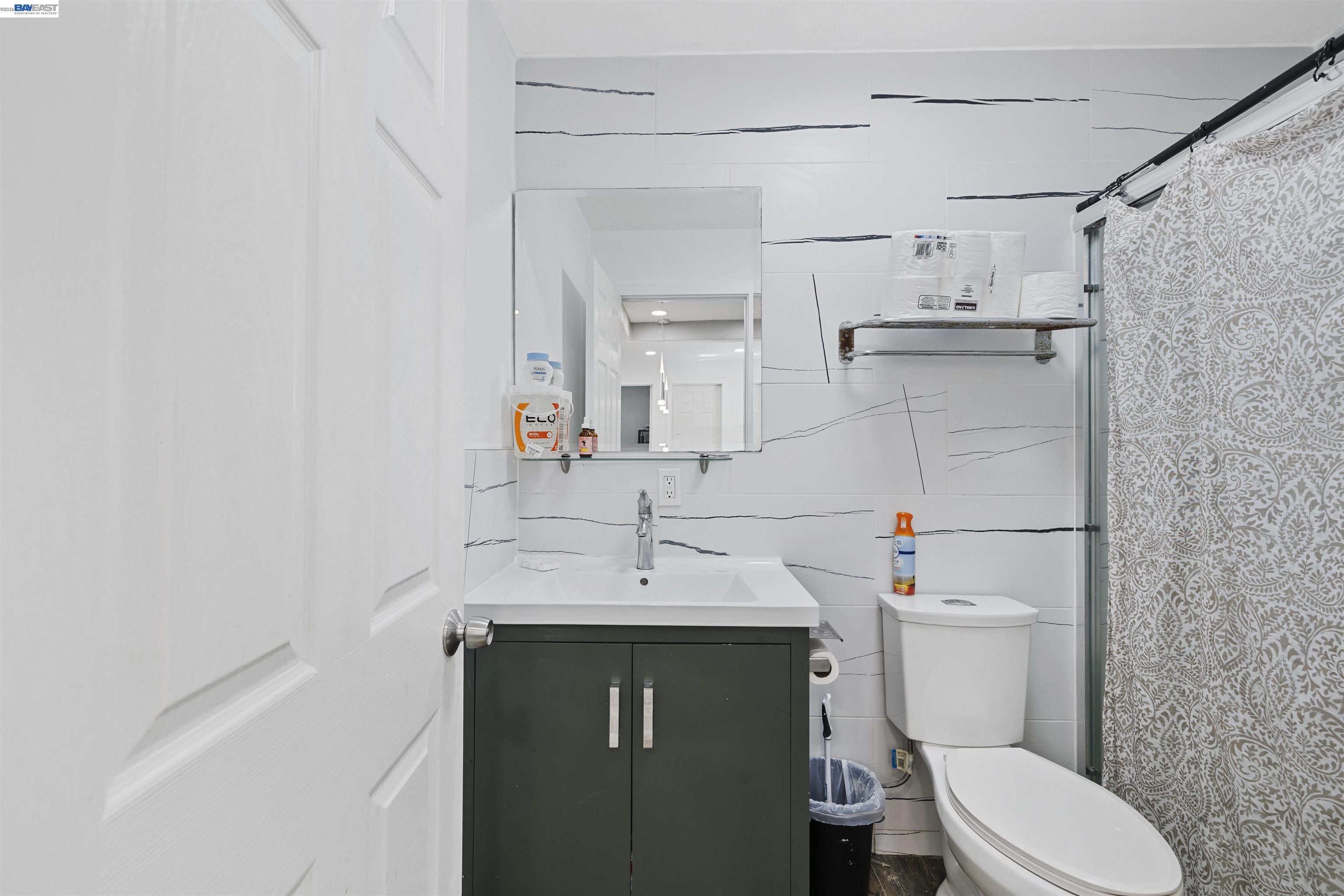 923 Kelvin Road El Sobrante, CA 94803 - Photo 18 of 27 a bathroom with a sink toilet vanity and shower