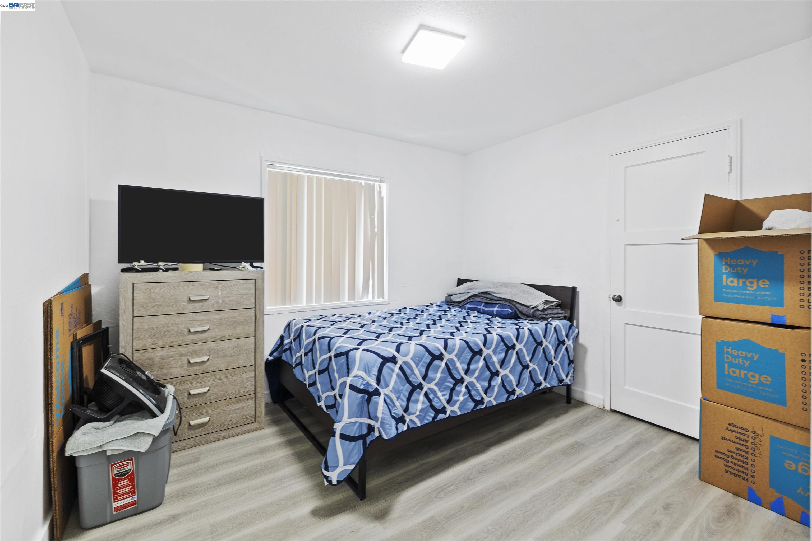 923 Kelvin Road El Sobrante, CA 94803 - Photo 20 of 27 a bedroom with a bed and flat screen tv