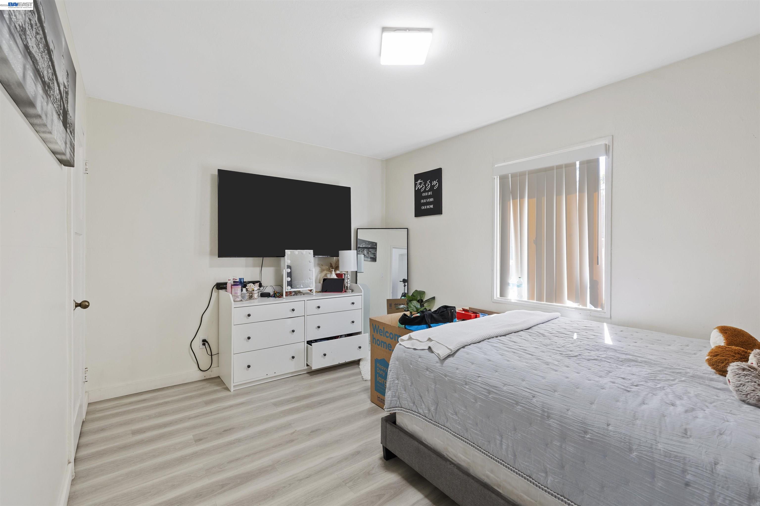923 Kelvin Road El Sobrante, CA 94803 - Photo 21 of 27 a bedroom with a bed and flat screen tv