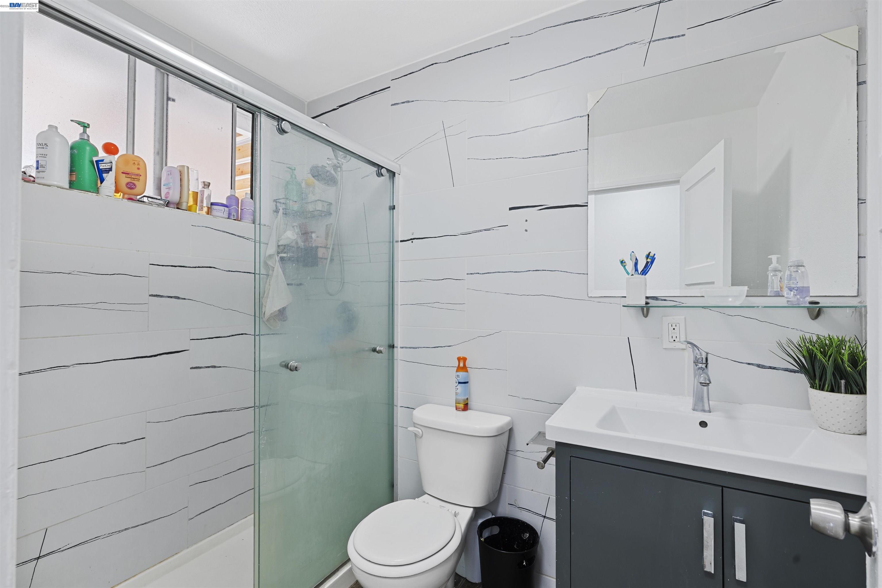 923 Kelvin Road El Sobrante, CA 94803 - Photo 23 of 27 a bathroom with a sink a toilet and shower