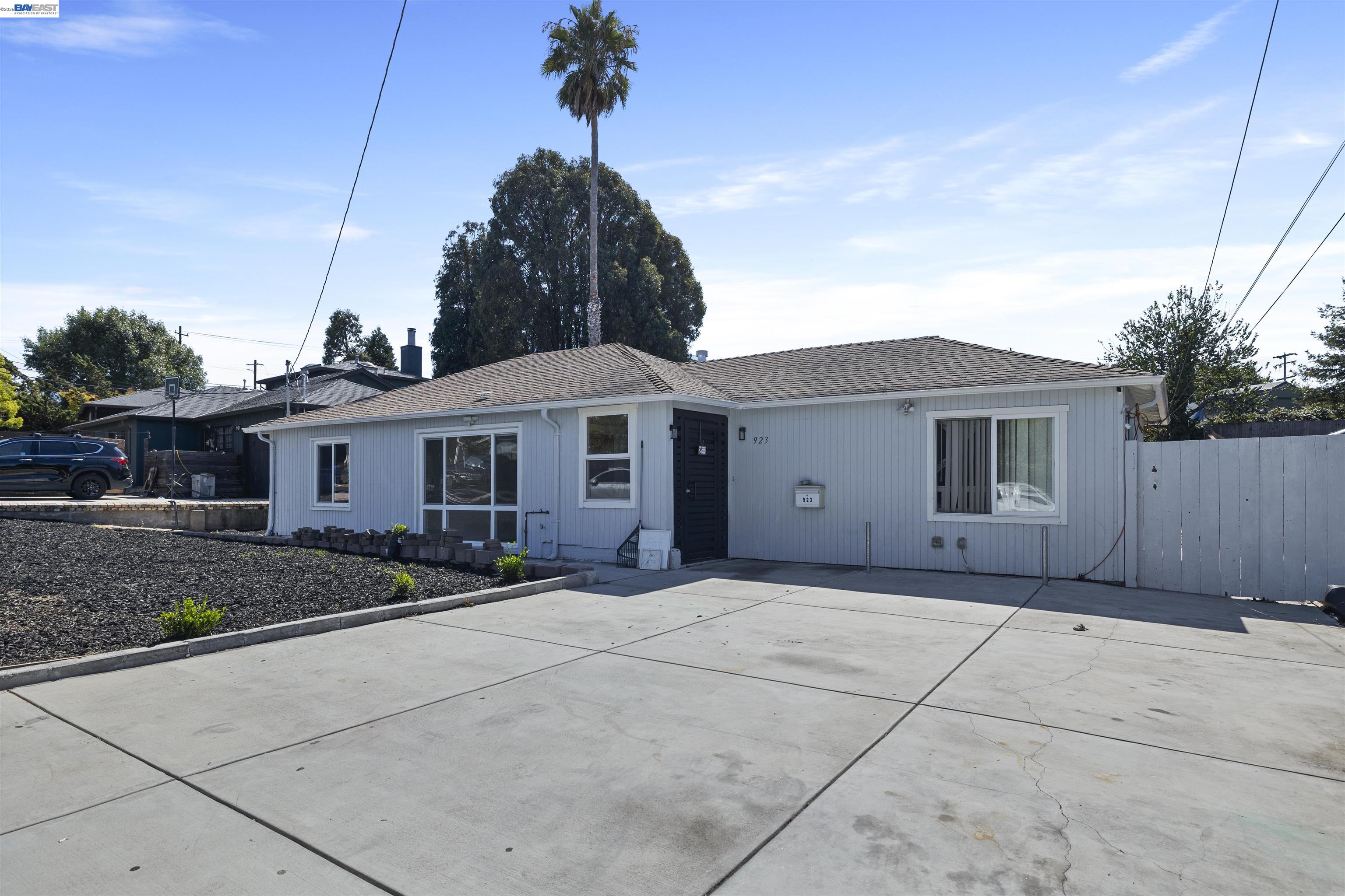 923 Kelvin Road El Sobrante, CA 94803 - Photo 3 of 27 a front view of a house with a yard and garage