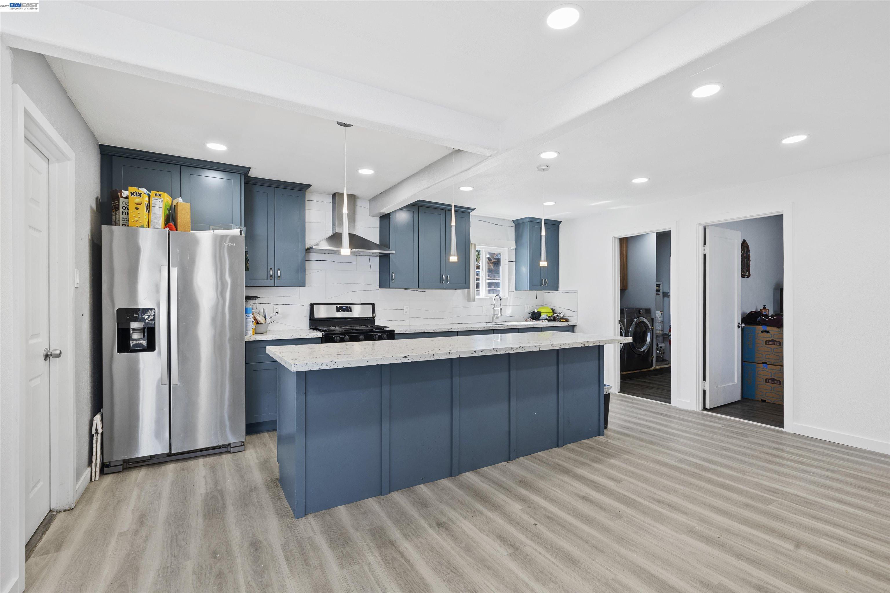923 Kelvin Road El Sobrante, CA 94803 - Photo 5 of 27 a large kitchen with kitchen island a sink stainless steel appliances and cabinets