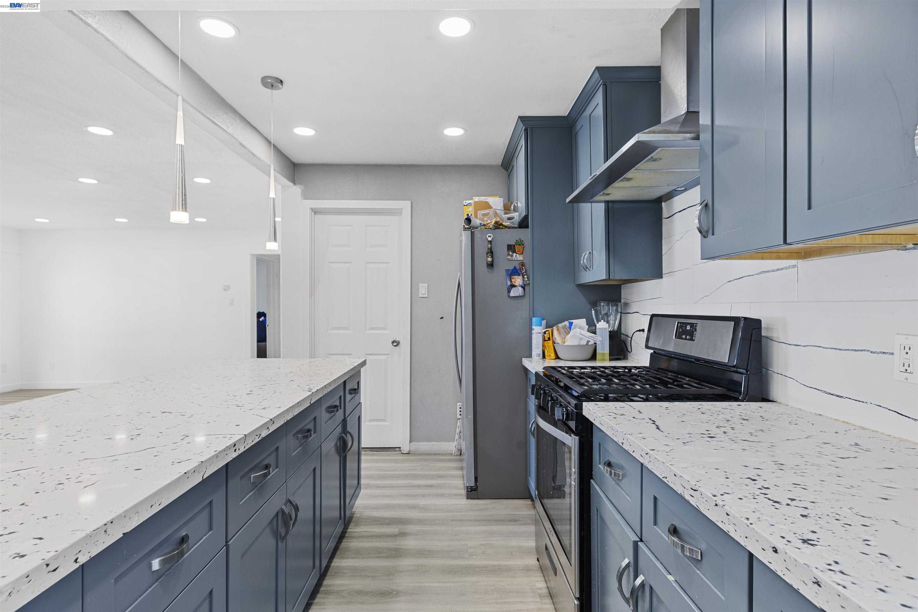 923 Kelvin Road El Sobrante, CA 94803 - Photo 6 of 27 a kitchen with stainless steel appliances granite countertop a sink stove and refrigerator