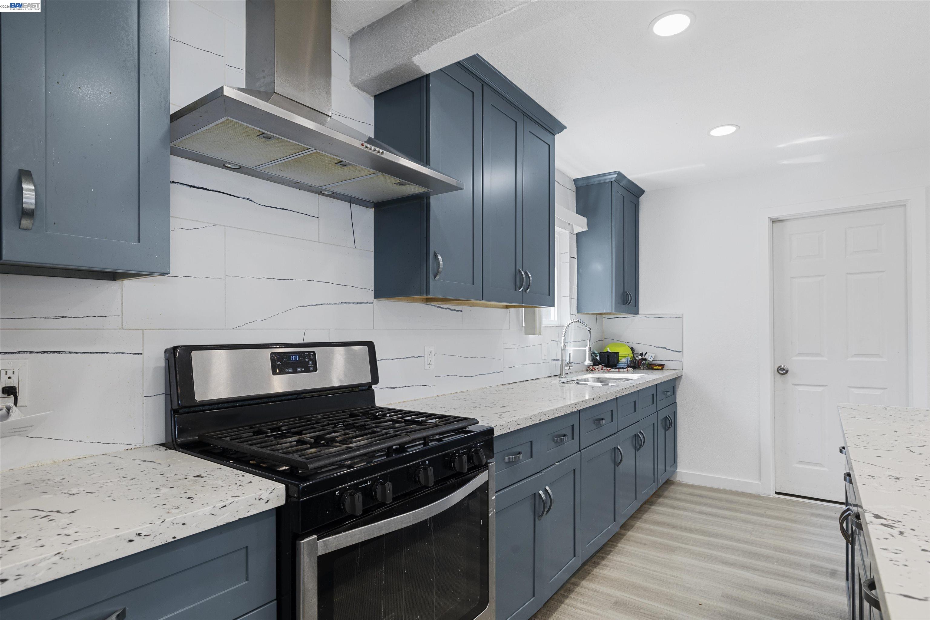 923 Kelvin Road El Sobrante, CA 94803 - Photo 7 of 27 a kitchen with stainless steel appliances granite countertop a stove a sink and a refrigerator