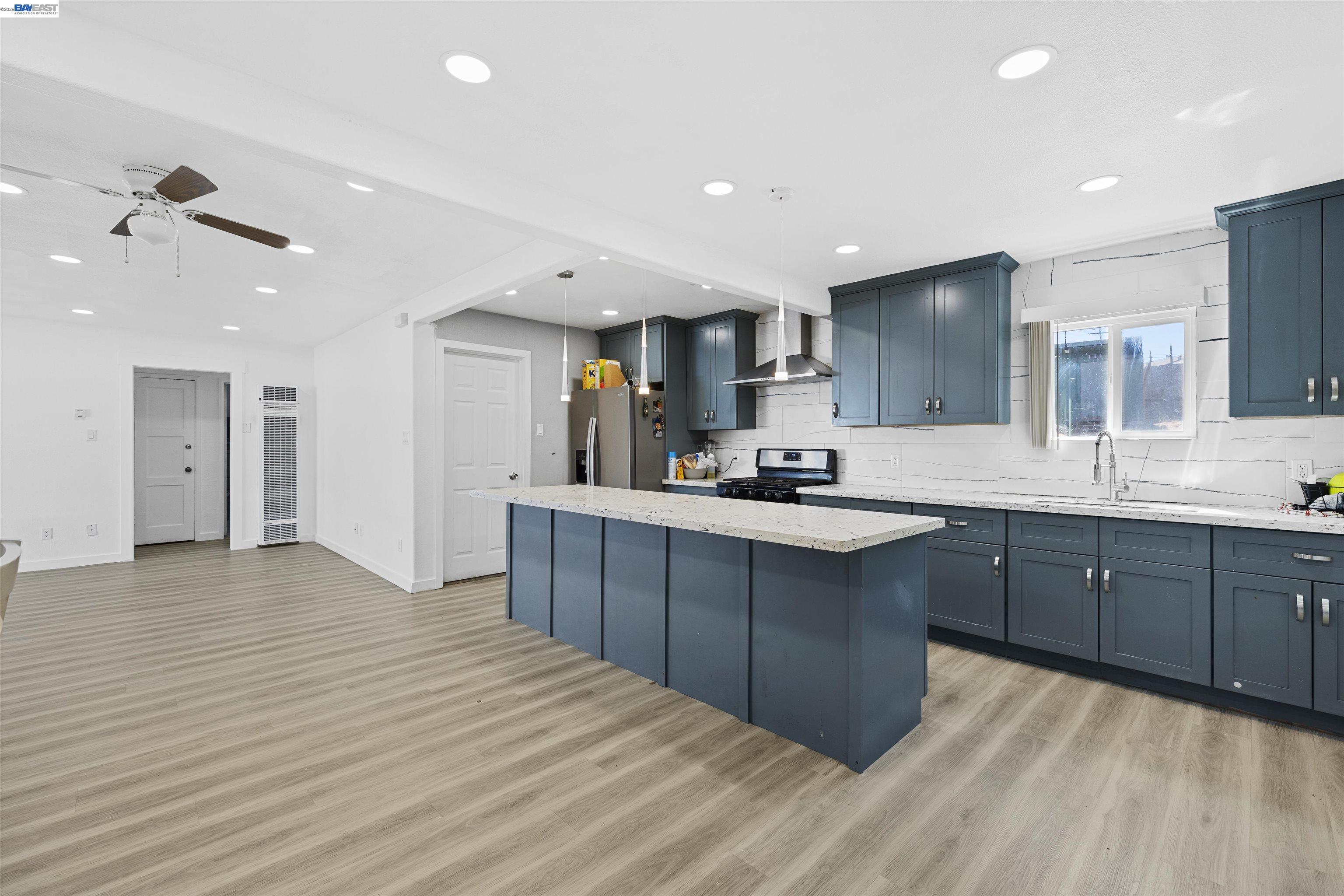923 Kelvin Road El Sobrante, CA 94803 - Photo 10 of 27 a kitchen with stainless steel appliances kitchen island granite countertop a sink and cabinets