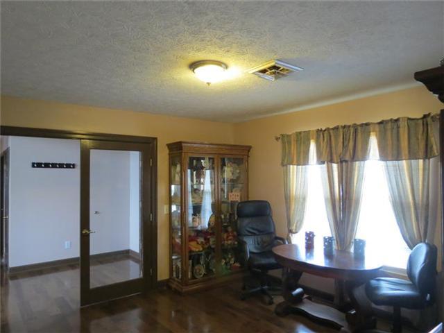 4755 South Qualls Road Adams, TN 37010 - Photo 3 of 20 Large formal dining room with glass french doors and hardwood floors welcomes your guest as they enter the front door. This is the perfect room for Christmas dinner with the family.
