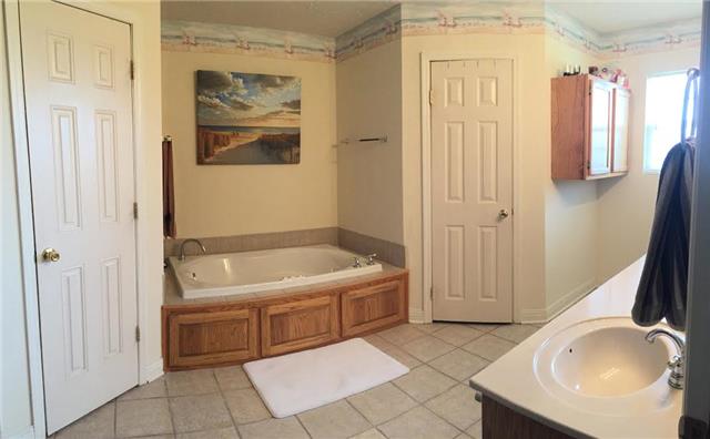 4755 South Qualls Road Adams, TN 37010 - Photo 6 of 20 Master bathroom features separate shower and tub, his/her walk-in closets, dual vanities and is handicapped accessible.