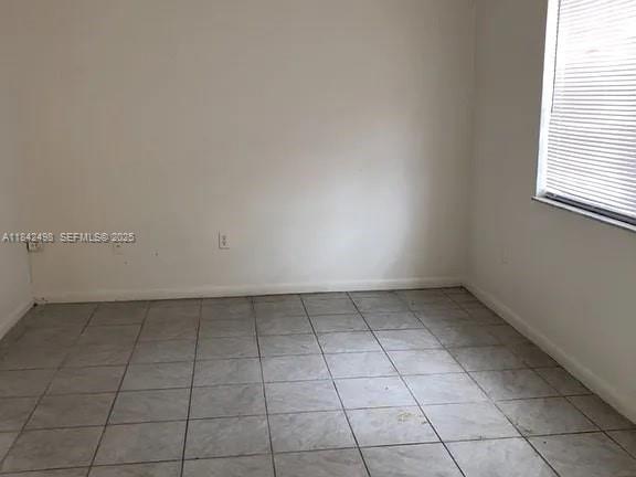 2524 Congress Street, Unit 7 Fort Myers, FL 33901 - Photo 2 of 10 an empty room with a white cabinet and a window