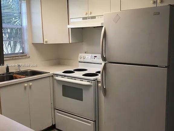 2524 Congress Street, Unit 7 Fort Myers, FL 33901 - Photo 3 of 10 a white refrigerator freezer sitting inside of a kitchen