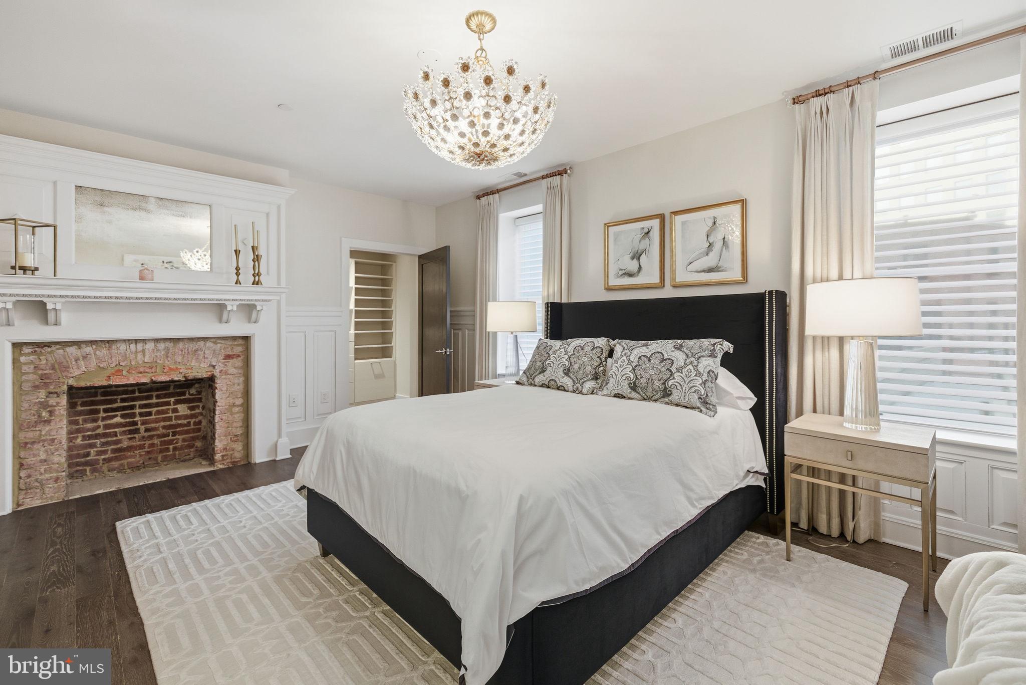 1745 N Street Northwest, Unit 113 Washington, DC 20036 - Photo 12 of 17 a spacious bedroom with a large bed and a fireplace