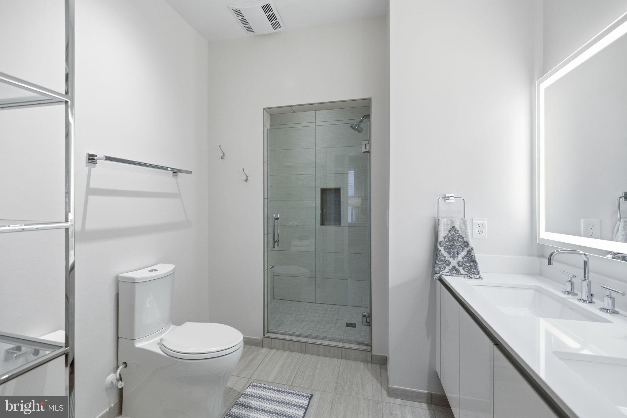 1745 N Street Northwest, Unit 113 Washington, DC 20036 - Photo 14 of 17 a bathroom with a granite countertop sink toilet and shower