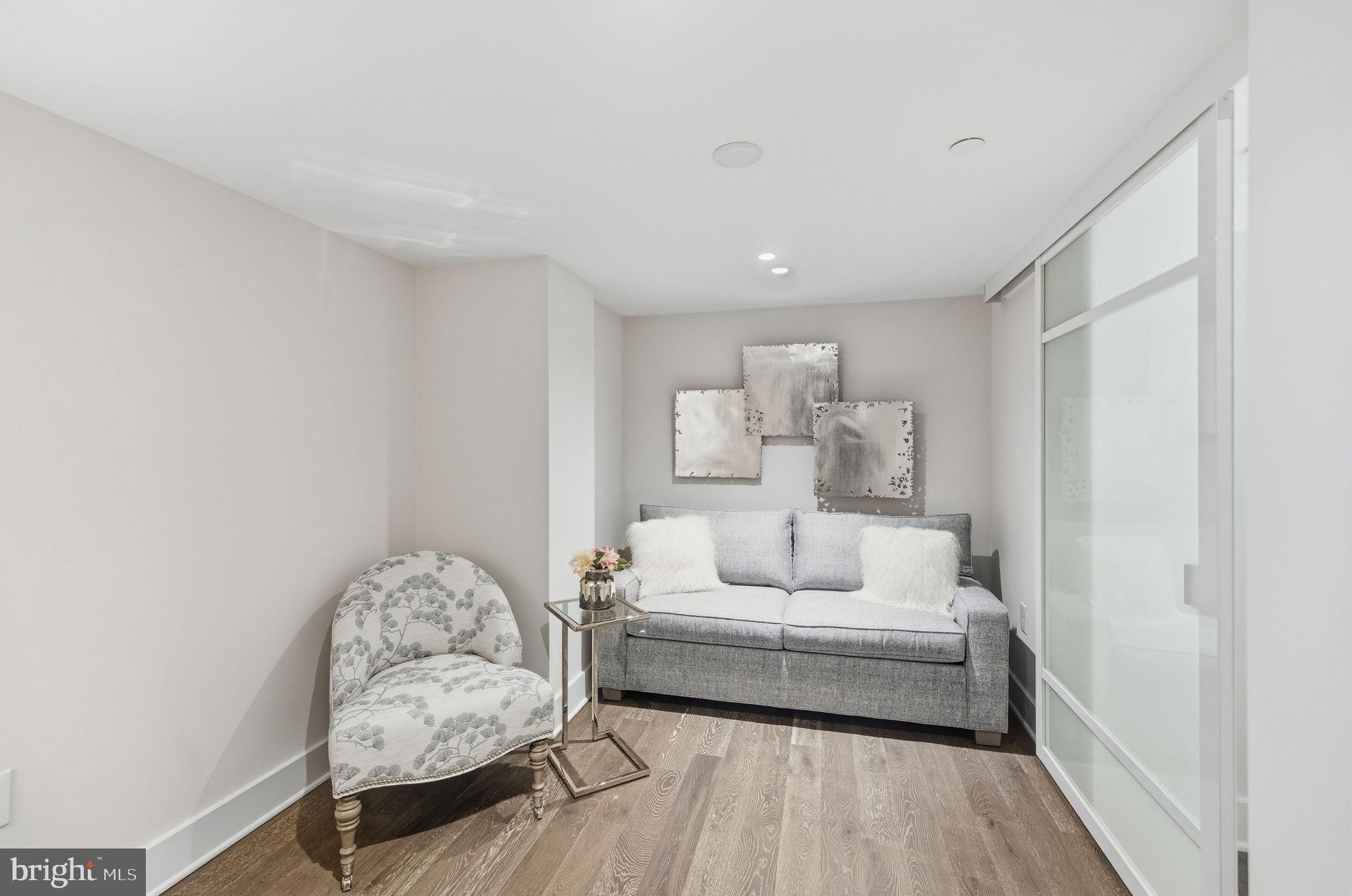 1745 N Street Northwest, Unit 113 Washington, DC 20036 - Photo 16 of 17 a bedroom with furniture and a wooden floor