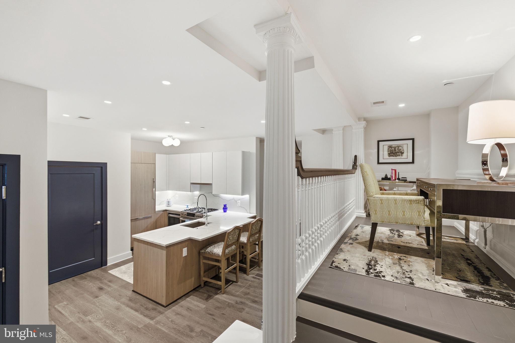 1745 N Street Northwest, Unit 113 Washington, DC 20036 - Photo 4 of 17 a kitchen with stainless steel appliances kitchen island granite countertop a sink and cabinets
