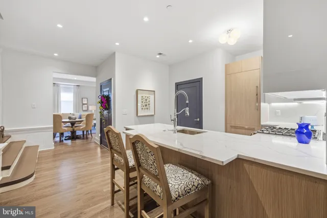 a view of a dining room with furniture and a chandelier