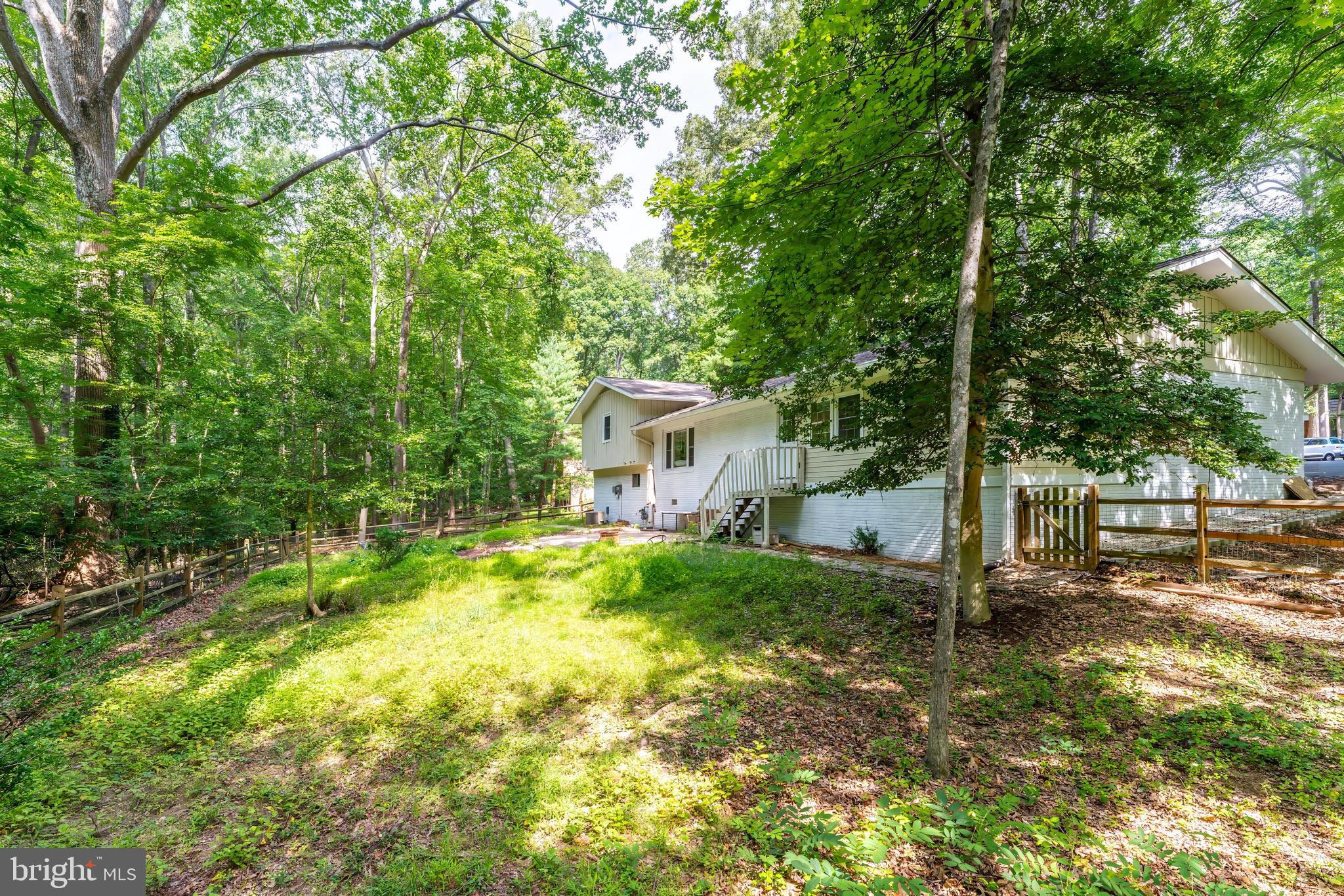 11621 Sourwood Lane Reston, VA 20191 - Photo 4 of 26 a view of a house with backyard and a tree