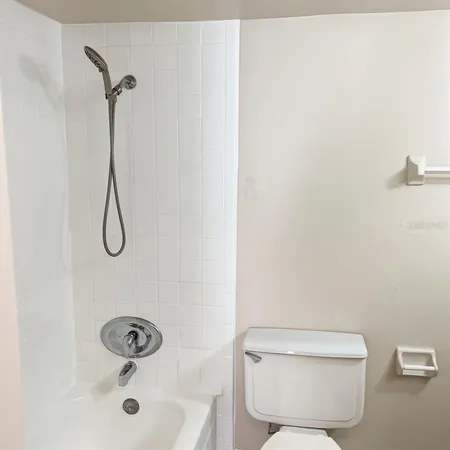 a bathroom with a toilet sink and shower