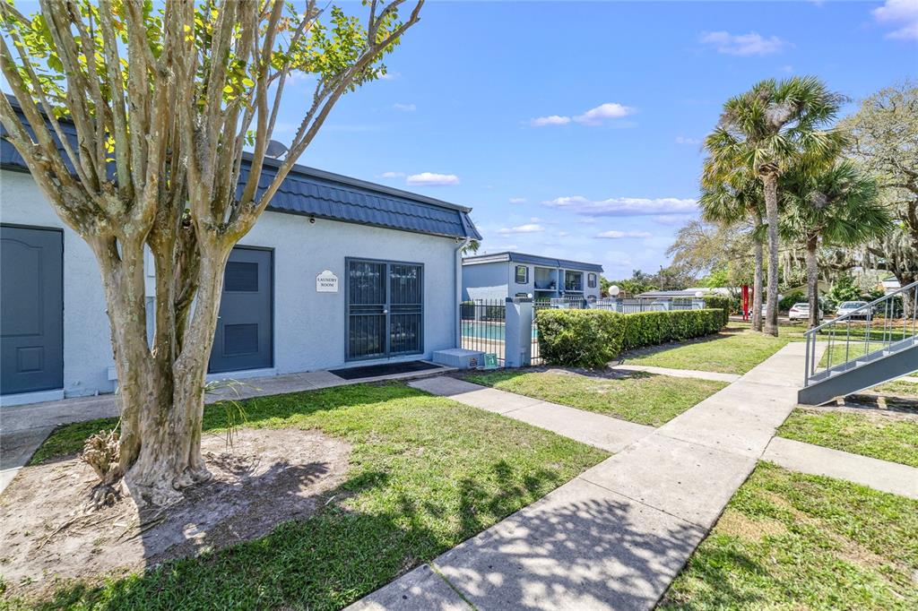 5200 Curry Ford Road, Unit 102 Orlando, FL 32812 - Photo 20 of 23 a tree in front of a house with a yard