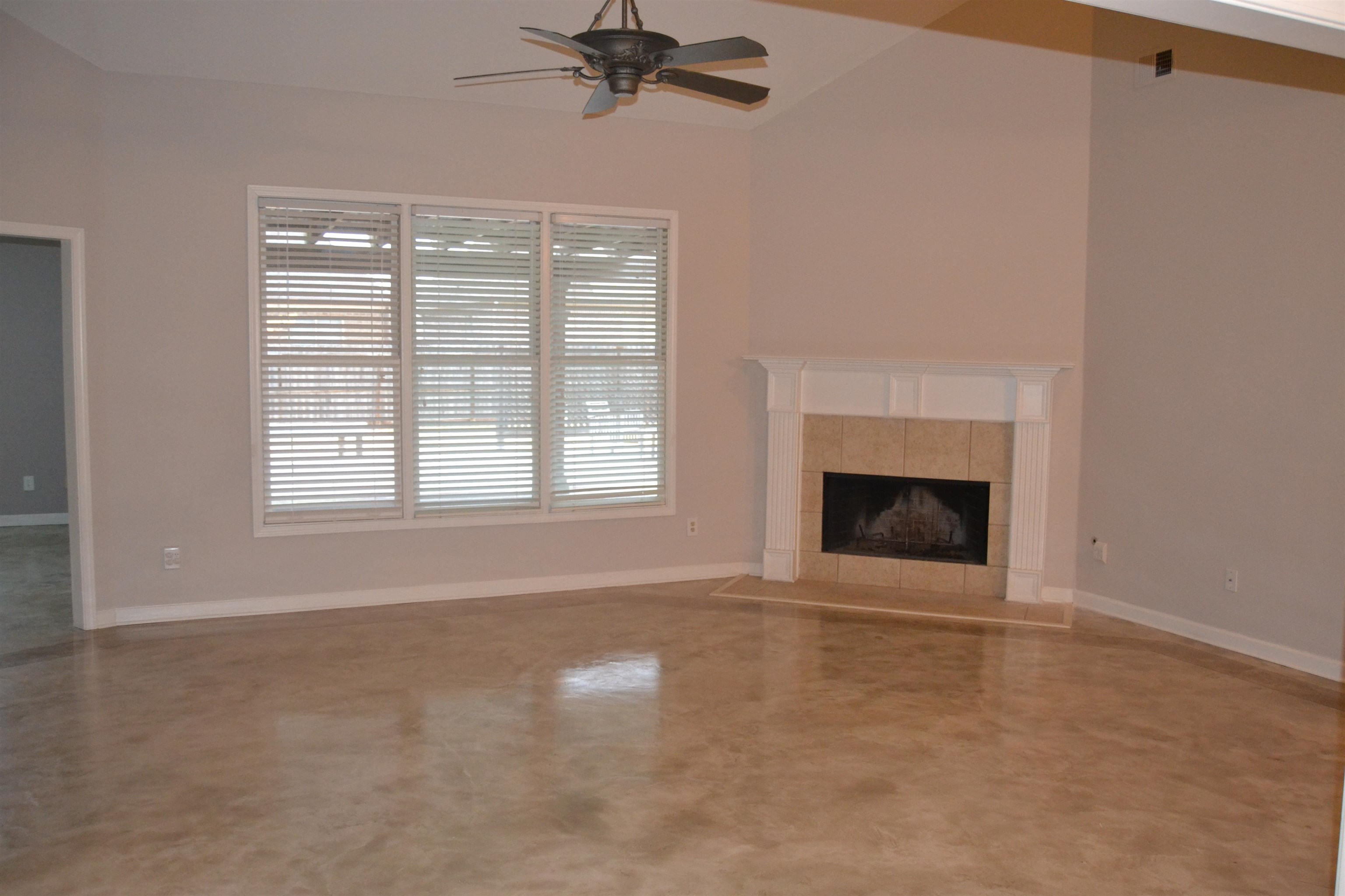 10486 Juneau Way Collierville, TN 38017 - Photo 5 of 33 Unfurnished living room with ceiling fan, a fireplace, and vaulted ceiling