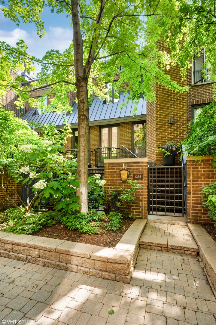1335 North Sutton Place Chicago, IL 60610 - Photo 1 of 31 a front view of a house with a yard