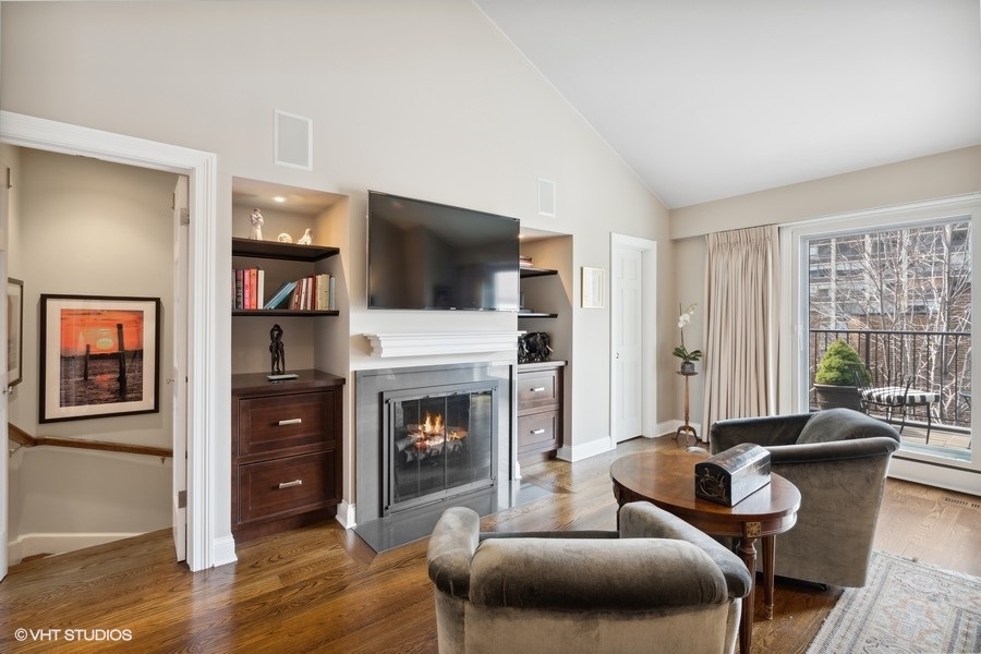 1335 North Sutton Place Chicago, IL 60610 - Photo 12 of 31 a living room with furniture and a fireplace