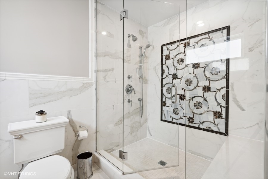 1335 North Sutton Place Chicago, IL 60610 - Photo 15 of 31 a bathroom with a shower toilet and a shower