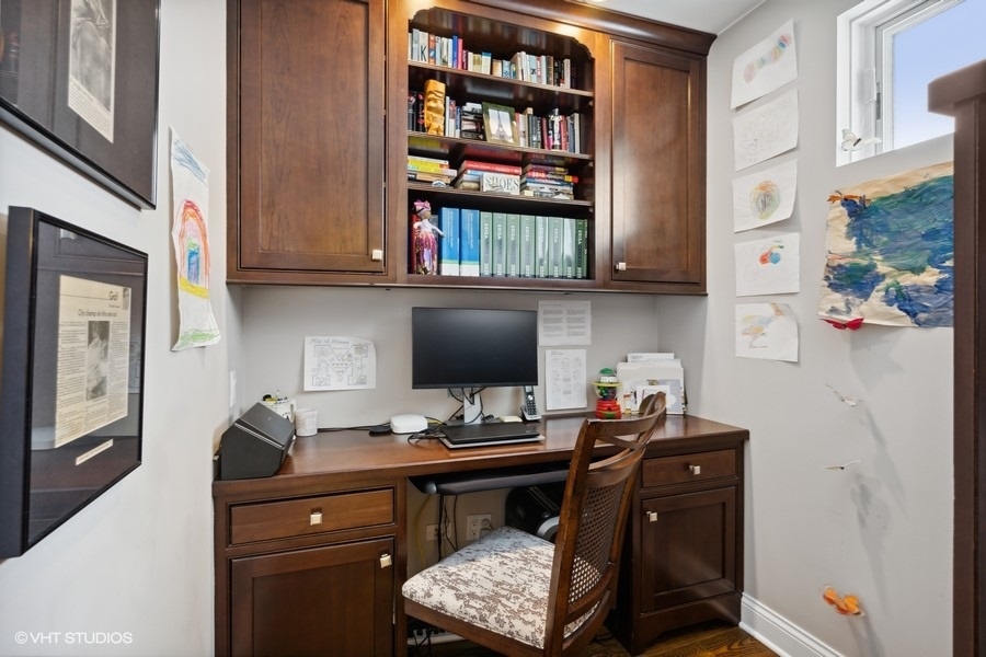1335 North Sutton Place Chicago, IL 60610 - Photo 18 of 31 a room with a workspace and a bookshelf