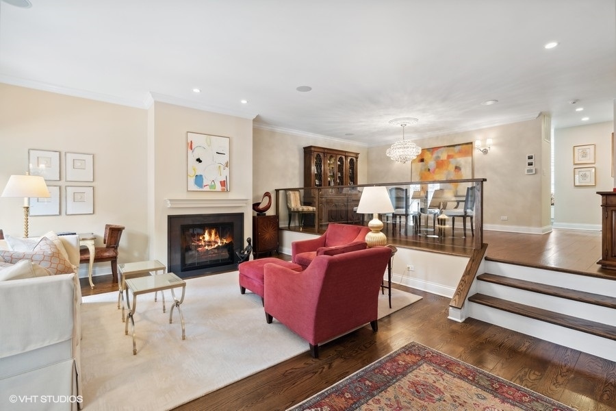 1335 North Sutton Place Chicago, IL 60610 - Photo 2 of 31 a living room with furniture and a fireplace