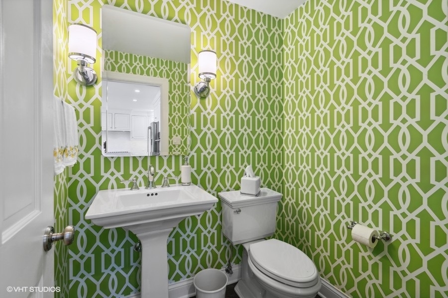 1335 North Sutton Place Chicago, IL 60610 - Photo 22 of 31 a bathroom with a toilet a sink and a shower curtain