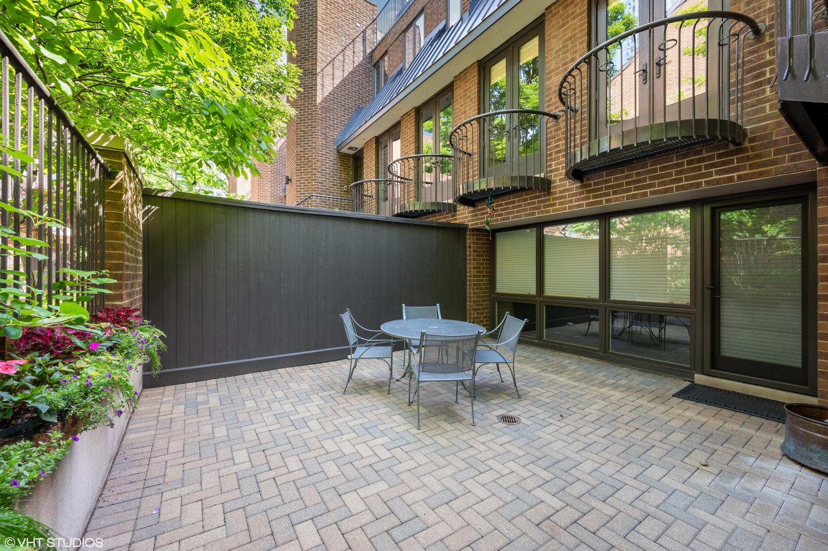 1335 North Sutton Place Chicago, IL 60610 - Photo 24 of 31 a roof deck with table and chairs and potted plants