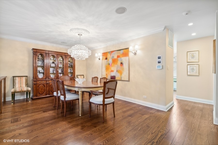 1335 North Sutton Place Chicago, IL 60610 - Photo 4 of 31 a view of a dining room with furniture window and wooden floor