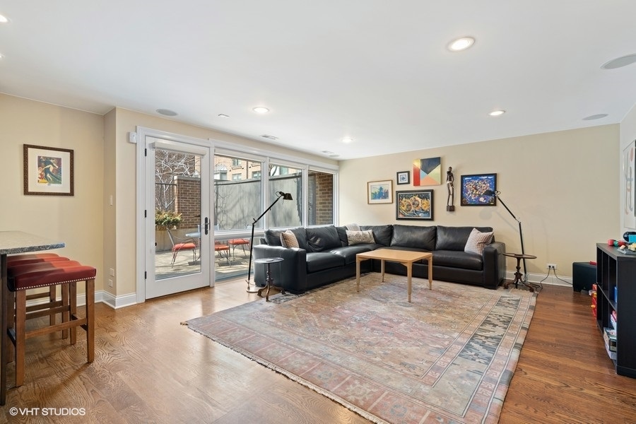 1335 North Sutton Place Chicago, IL 60610 - Photo 8 of 31 a living room with furniture and a large window