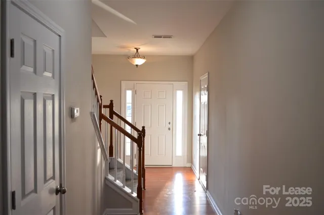 a view of an entryway with wooden floor