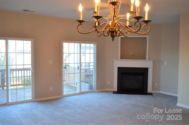 a view of a livingroom with a fireplace and window