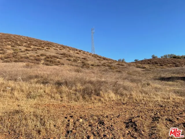 a view of a large building with mountains in the background