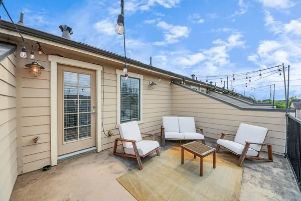 a roof deck with a table and chairs