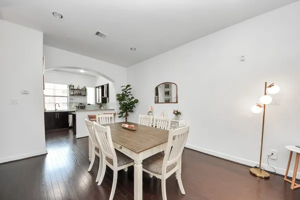 a dining room with furniture and wooden floor