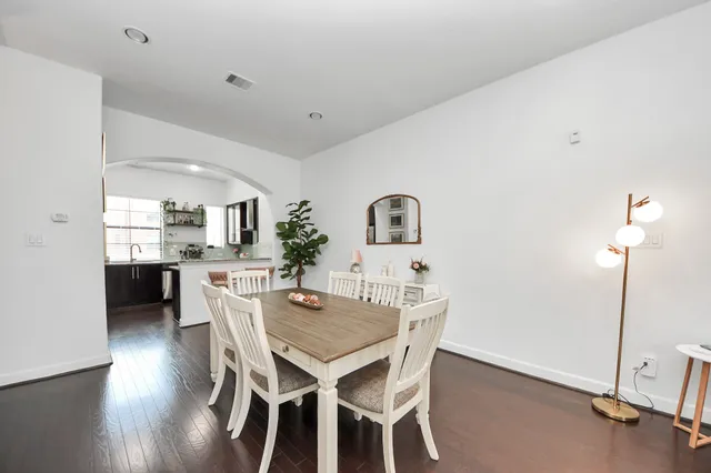 a dining room with furniture and wooden floor